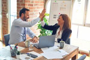 Crm Systems Blog Image Showing A Small Business Team High Fiving Photo By Krakenimages On Unsplash